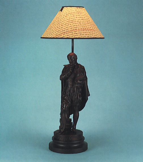 Shakespeare, bronzed lamp base with 12" indenture shade with black trim.