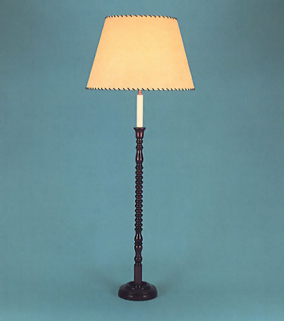 Bobbin, mahogany lamp base with 17" antique parchment shade with leather thonging.