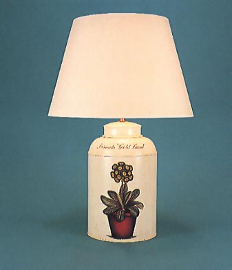 Flora Primula, tea canister lamp base, flora on barley white background with 17" plain parchment shade with  self coloured trim.